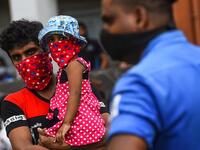Residents watch a music band formed by Sri Lankan Navy personnel as they play outside a housing complex during a government-imposed nationwide lockdown as a preventive measure against the COVID-19 coronavirus, in Colombo on April 9, 2020. ISHARA S. KODIKARA / AFP