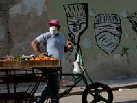 A fruits and vegetables seller wears a face mask in Havana, on April 11, 2020 amid the new coronavirus (COVID-19) pandemic. Cuba hit out at the United States on Friday over its nearly 60-year-old embargo against the island nation, which Havana described as "even more cruel" given the suffering caused by the new coronavirus pandemic. The communist-run single-party island is finding it tough to source medical supplies and has already recorded 620 coronavirus cases and 16 deaths. YAMIL LAGE / AFP