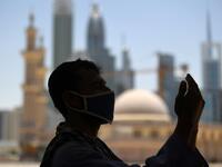 A mask-clad Muslim worker prays near a mosque on the first Friday of the holy fasting month of Ramadan, amidst a curfew due to the COVID-19 coronavirus pandemic, in Dubai on April 24, 2020. KARIM SAHIB / AFP