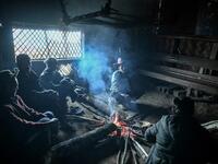 This photo taken on February 9, 2020 shows people resting inside their house in Karmawlawyi village in Myanmar's Sagaing region, near the border with India. The king of the Konyak tribe sleeps in Myanmar, but eats in India -- his house, village and people divided by a mountain border which serves as a vulnerable lifeline now severed by a coronavirus lockdown.  Ye Aung THU / AFP