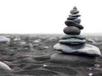 Pyramid from stones on the black sand beach in Iceland. The image close up  (Shutterstock)