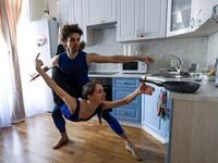 Bolshoi theatre leading soloist Igor Tsvirko and first soloist Margarita Shrainer attend a lesson in the kitchen of their apartment in Moscow on April 29, 2020 during a strict lockdown in Russia to stop the spread of the COVID-19 infection caused by the novel coronavirus. In the middle of their bedroom. Kirill KUDRYAVTSEV / AFP