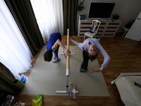 Bolshoi theatre leading soloist Igor Tsvirko and first soloist Margarita Shrainer attend a lesson in their apartment in Moscow on April 29, 2020 during a strict lockdown in Russia to stop the spread of the COVID-19 infection caused by the novel coronavirus. Kirill KUDRYAVTSEV / AFP