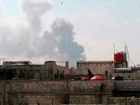 A handout picture released by the official Syrian Arab News Agency (SANA) on May 1, 2020, shows smoke billowing above buildings in Syria's central city of Homs. SANA said that the explosions ringing out of a Syrian army position in Homs resulted from a "human error during the transport of some ammunition, which led to human and material losses", while the Syrian Observatory for Human Rights, a Britain-based war monitor relying on sources inside Syria, said Israeli air strikes hit a missile depot belonging t