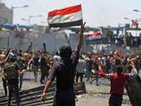 An Iraqi protester gestures the victory sign as some clash with security forces on Al-Jumhuriyah bridge in the capital Baghdad, during an anti-government demonstration on May 10,2020. Modest anti-government rallies resumed in some Iraqi cities today, clashing with security forces and ending months of relative calm just days after Prime Minister Mustafa Kadhemi's government came to power. AHMAD AL-RUBAYE / AFP