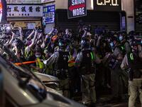 Riot police hold back members of the press during a police operation to arrest pro-democracy demonstrators during a protest calling for the city's independence in Mong Kok district of Hong Kong on May 10, 2020. ISAAC LAWRENCE / AFP