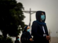 People wearing face masks and keeping their social distance, attend the 103rd anniversary of the apparitions of Our Lady of Fatima at the Fatima shrine in central Portugal on May 13, 2020. Without the crowd of pilgrims it welcomes every year, the shrine of Fatima celebrated the anniversary during a religious ceremony reduced to the bare minimum. PATRICIA DE MELO MOREIRA / AFP