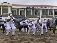 Nurses assigned to the Infectious Diseases Unit (IDU) at the Kenyatta University Hospital dance during a Zumba class held at the hospital compound in Nairobi, on May 17, 2020. Coinciding with the morning shift rotation the class, aimed to offer some respite to nurses charged with the management of patients infected with COVID-19 coronavirus, was organised by the Nursing Council of Kenya (NCK) and the Kenyatta Univesity Teaching, Refferal and Research Hospital in the Kenyan capital. TONY KARUMBA / AFP