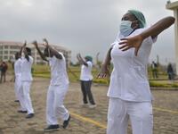 Nurses assigned to the Infectious Diseases Unit (IDU) at the Kenyatta University Hospital dance during a Zumba class held at the hospital compound in Nairobi, on May 17, 2020. Coinciding with the morning shift rotation the class, aimed to offer some respite to nurses charged with the management of patients infected with COVID-19 coronavirus, was organised by the Nursing Council of Kenya (NCK) and the Kenyatta Univesity Teaching, Refferal and Research Hospital in the Kenyan capital. TONY KARUMBA / AFP