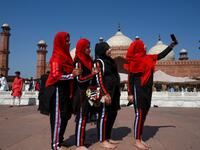 Muslim women take selfies after offering Eid al-Fitr prayers at the Badshahi Mosque in Lahore on May 24, 2020. Muslims around the world began marking a sombre Eid al-Fitr on May 24, many under coronavirus lockdown, but lax restrictions offer respite to worshippers in some countries despite fears of skyrocketing infections. Arif ALI / AFP
