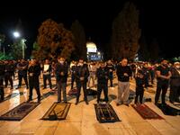 Palestinians perform the dawn prayer (salat al-fajr) inside the al-Aqsa mosque compound, in Jerusalem's Old City on May 31, 2020, after a two-month closure due to the COVID-19 pandemic. AHMAD GHARABLI / AFP