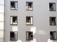Guests of Zeitgeist Hotel listen from their rooms to singers Monika Medek and Dagmar Dekanovsky and the Camerata Carnutum orchestra, during a window concert (Fensterkonzert) in Vienna on May 30, 2020, as hotels have reopened in Austria amid the novel coronavirus pandemic. JOE KLAMAR / AFP