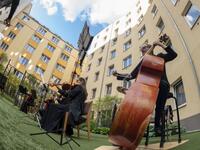 Guests of Zeitgeist Hotel listen from their rooms to singers Monika Medek and Dagmar Dekanovsky and the Camerata Carnutum orchestra, during a window concert (Fensterkonzert) in Vienna on May 30, 2020, as hotels have reopened in Austria amid the novel coronavirus pandemic. JOE KLAMAR / AFP