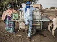Fulani herders fill up their water tanks to take back to their camp at a unofficial herders market in Barkedji on May 28, 2020. Access to water comes at a price, many families must travel up to ten kilometres everyday to fill up their water supply, which then will be used for their livestock and themselves. COVID-19 coronavirus restrictions have closed down markets and regional movement, as a result Fulani herders are struggling to move to areas with more grazing land for there live stock. JOHN WESSELS / AF