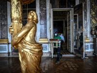 A worker carries furniture in the Galerie des Glaces (Hall of Mirrors) at the Chateau de Versailles (Palace of Versailles) in Versailles near Paris, on June 5, 2020 on the eve of it re-opening after 82 days of closure due to the novel coronavirus (COVID-19) outbreak. The Palace of Versailles -- France's big tourist attraction with nearly 10 million tourists a year - will open on June 6 with no US or Asia tourists who represent 30% of its visitors. STEPHANE DE SAKUTIN / AFP