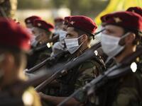 Members of the Hashed al-Shaabi (Popular Mobilisation) paramilitary force take part in a military parade in the southern Iraqi city of Basra on June 14, 2020, marking the sixth anniversary of its founding after Iraq's top Shiite cleric Grand Ayatollah Ali Sistani called to defend the country from the Islamic State group (IS). Hussein FALEH / AFP