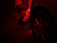 This picture taken on June 15, 2020 shows actor Kota Hanegawa, 28, acting as a victim during a demonstration of a haunted house at a garage in Tokyo. A car horn beeps and the horror begins: a bloody murder and rampaging zombies. But this drive-in haunted house in Japan protects against the most terrifying enemy of all -- coronavirus. Inside a car, guests can scream as loudly as they like, with no mask required, as hideous creatures daubed in blood swarm towards them.  Philip FONG / AFP