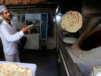 Iranian baker Mohammad Mirzakhani, 41, makes Taftoon bread in Tehran on June 13, 2020. ATTA KENARE / AFP