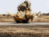 A landmine is remotely detonated in a field at a pistachio orchard in the village of Maan, north of Hama in west-central Syria on June 24, 2020. Pistachio farmers in central Syria are hoping that reduced violence will help revive cultivation of what was once one of the country's top exports. LOUAI BESHARA / AFP