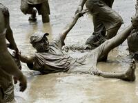 Mud-covered farmers play in a rice paddy field during "National Paddy Day", which marks the start of the annual rice planting season, in Tokha village on the outskirts of Kathmandu on June 29, 2020. Splashing mud and drinking local rice beer, Nepali farmers this week celebrated National Paddy Day to mark the beginning of the rice-planting season, despite some coronavirus lockdown measures still in place. Traditional farming songs and laughter echoed in the air as farmers waded into waterlogged fields to sow
