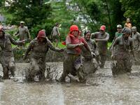 Mud-covered farmers play in a rice paddy field during "National Paddy Day", which marks the start of the annual rice planting season, in Tokha village on the outskirts of Kathmandu on June 29, 2020. PRAKASH MATHEMA / AFP