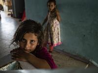 A girl looks on in the stairwell of a school building where Syrians -- displaced from the area of Ras al-Ain by the Turkish offensive on the northeast -- are staying in the city of Hasakah, on June 30, 2020. Delil SOULEIMAN / AFP