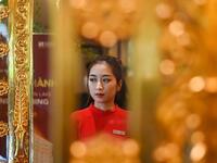 A staff member waits to welcome guests in the lobby of the newly-inaugurated Dolce Hanoi Golden Lake hotel, the world's first gold-plated hotel, in Hanoi on July 2, 2020. Manan VATSYAYANA / AFP
