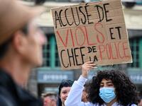 A protester holds a placard reading 'accused of rape and police chief' during a demonstration called by feminist movements on the main square of Lille, on July 10, 2020, to denounce the nomination of French Interior Minister, facing rape accusations and French Justice Minister who criticised the #MeToo movement against sexual harassment. DENIS CHARLET / AFP