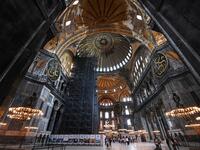 Tourists visit the inside of Hagia Sophia on July 10, 2020, in Istanbul, before a top Turkish court revoked the sixth-century Hagia Sophia's status as a museum, clearing the way for it to be turned back into a mosque. The Council of State, the country's highest administrative court which on July 2 debated a case brought by a Turkish NGO, cancelled a 1934 cabinet decision and ruled the UNESCO World Heritage site would be reopened to Muslim worshipping. The sixth-century Istanbul building -- a magnet for tour