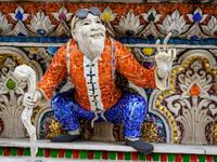 This photograph taken on July 14, 2020 shows the Dragon Ball manga character Master Roshi on the facade of the Wat Pariwat Buddhist temple in Bangkok. Wat Pariwat, also known as "the David Beckham Temple", is decorated with statues of superheroes and comic characters as well as mythical and imaginary creatures. A golden-plated sculpture of the English football player holding the base of a Buddha statue in one of the buildings gives the temple its nickname. Mladen ANTONOV / AFP