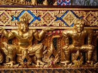 This photograph taken on July 14, 2020 shows a gold-plated sculpture of British football player David Beckham (R) in a Manchester United jersey at the base of a Buddha statue at the Wat Pariwat Buddhist temple in Bangkok. Wat Pariwat, also known as "the David Beckham Temple", is decorated with statues of superheroes and comic characters as well as mythical and imaginary creatures. A golden-plated sculpture of the English football player holding the base of a Buddha statue in one of the buildings gives the t