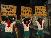 Israeli demonstrators lift placards during a rally against Prime Minister Benjamin Netanyahu outside his official residence in Jerusalem, on July 18, 2020, amid the coronavirus pandemic. Israeli police fired water cannons to disperse anti-government protests attended by thousands on Saturday, as public anger mounts over the handling of the coronavirus crisis. 