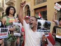 Demonstrators hold placards as they take part in a rally in front of the World Bank offices in the downtown district of the Lebanese capital Beirut on July 25, 2020, to protest against the Bisri dam project, partly financed by the World Bank. The government says the Bisri dam is vital to tackling chronic water shortages. But activists say it will ravage most of the region's farmland and historic sites, and they also fear the consequences of building it on a seismic fault line.  ANWAR AMRO / AFP