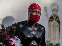 A Catholic faithful smeared in burnt oil poses for a picture as he takes part in the opening of the ten-day celebration of the Santo Domingo de Guzman festival, outside the Las Sierritas de Santo Domingo church in Managua, on August 1, 2020 amid the COVID-19 novel coronavirus pandemic. Despite the Catholic Church cancelling all religious activities due to the coronavirus pandemic, devotees gathered outside the church for the celebration. Inti OCON / AFP