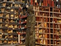 The statue of the Lebanese Emigrant stands intact in front of damaged buildings at the entrance of Beirut's port following a powerful explosion in its vicinity in Lebanon's capital on August 4, 2020. Marwan TAHTAH / AFP