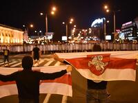 Demonstrators stand in front of riot police during a protest after polls closed in Belarus' presidential election, in Minsk on August 9, 2020. Sergei GAPON / AFP