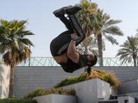 Hamzar Mekkaoui, 26, performs parkour, a sport that originated in France in the 1990s, which involves getting around urban obstacles with a fast-paced mix of jumping, vaulting, running and rolling, in the Qatari capital Doha, on August 11, 2020. Parkour, also known as free-running, has now found a small but committed following in Qatar despite evening temperatures that hover around 40 degrees Celsius (104 Fahrenheit) in summer and over-zealous security guards unfamiliar with the sport. KARIM JAAFAR / AFP