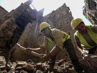 Yemeni labourers remove the rubble ahead of restoration works on the site of a collapsed UNESCO-listed building following heavy rains, in the old city of the Yemeni capital Sanaa, on August 12, 2020. Flash floods triggered by torrential rains have killed at least 172 people across Yemen over the past month, damaging homes and UNESCO-listed world heritage sites, officials said. Mohammed HUWAIS / AFP
