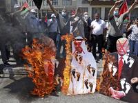Palestinian protesters set aflame cut-outs showing the faces of (L to R) Israeli Prime Minister Benjamin Netanyahu, Abu Dhabi Crown Prince Sheikh Mohammed bin Zayed al-Nahyan, and US President Donald Trump, during a demonstration in Nablus in the occupied West Bank on August 14, 2020 against a US-brokered deal between Israel and the UAE. AFP