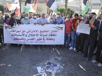 Palestinian protesters lift a banner during a demonstration against the Emirati-Israeli agreement in Ramallah in the occupied West Bank, on August 15, 2020. ABBAS MOMANI / AFP