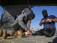 Palestinians prepare incendiary devices before being attached to inflated condoms and plastic bags, to be directed and flown towards Israel, near Rafah along the border between the Gaza Strip and Israel on August 21, 2020. SAID KHATIB / AFP