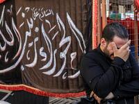 A man weeps on the side of a procession commemorating the entry of Imam Hussein and his family and retinue into Karbala, as Shiite Muslims mark the Ashura period in Iraq's central holy shrine city on August 22, 2020. Ashura is a period of mourning in remembrance of the seventh-century martyrdom of Prophet Mohammad's grandson Imam Hussein, who was killed in the battle of Karbala in modern-day Iraq, in 680 AD. Mohammed SAWAF / AFP