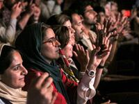 Women audience members applaud as they attend a performance by the Iranian all-women music band "Dingo" during the state-organised "Persian Gulf music" festival at Avini Hall in Iran's southern Gulf port city of Bandar Abbas on April 29, 2019.ATTA KENARE / AFP