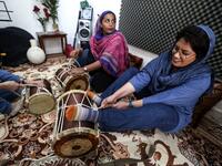 (L to R) Pippeh drummer Malihe Shahinzadeh and drummer Faezeh Mohseni practise together with other band members at a home studio called the "Dingo room" in Iran's southern Gulf port city of Bandar Abbas on April 30, 2019. ATTA KENARE / AFP