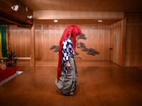 This photo taken on July 29, 2020 shows performer Kennosuke Nakamori posing with a red wig, or "akagashira", after an interview with AFP at the Kamakura Noh Theatre in the town of Kamakura in Kanagawa Prefecture, about one hour southwest of Tokyo. Philip FONG / AFP