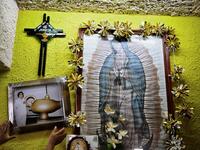 Mexican criminologist Maira de Rosas Silva puts a portrait of her mother, Mexican nurse Juana Silva Isidoro, who died of the novel coronavirus, COVID-19, on an altar in her house in Xochimilco neighbourhood in Mexico City on August 16, 2020. Global deaths from the coronavirus have almost reached on September 25, 2020 the grim threshold of one million. Around one-third of fatalities were in Latin America, where countries with overstretched medical resources are preparing for a further onslaught. Alfredo ESTR