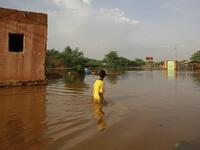 A Sudanese boy wades through a flooded street at the area of al-Qamayir in the capital's twin city of Omdurman, on August 26, 2020.ASHRAF SHAZLY / AFP
