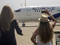 A picture taken on August 31, 2020, shows Israeli women taking pictures of the El Al's airliner, ahead of the first-ever commercial flight from Israel to the UAE at the Ben Gurion Airport near Tel Aviv, which will carry a US-Israeli delegation to the UAE following a normalisation accord. Heidi levine / POOL / AFP