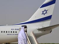 An Emirati official stands near an air-plane of El Al, which carried a US-Israeli delegation to the UAE following a normalisation accord, upon it's arrival at the Abu Dhabi airport in the first-ever commercial flight from Israel to the UAE, on August 31, 2020. KARIM SAHIB / AFP