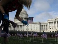 People place US flags in the ground to honor the victims of the 9/11 terrorist attack outside the US Capitol Building on September 11, 2020 in Washington, D.C. Alex Edelman / AFP